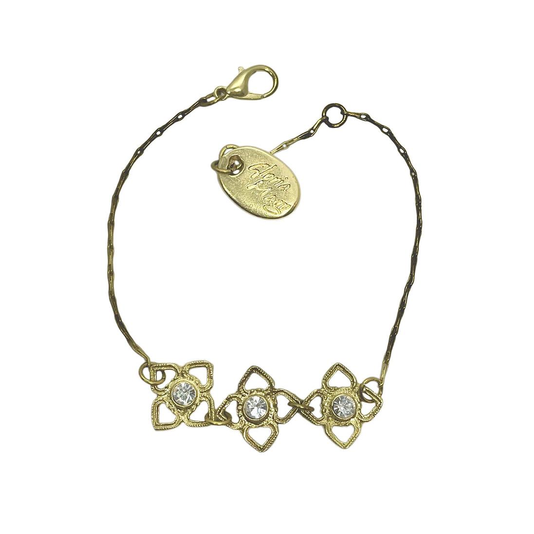 Pulsera Mismy dorado Tres flores y cristal SW color cristal marca Gloria Mago