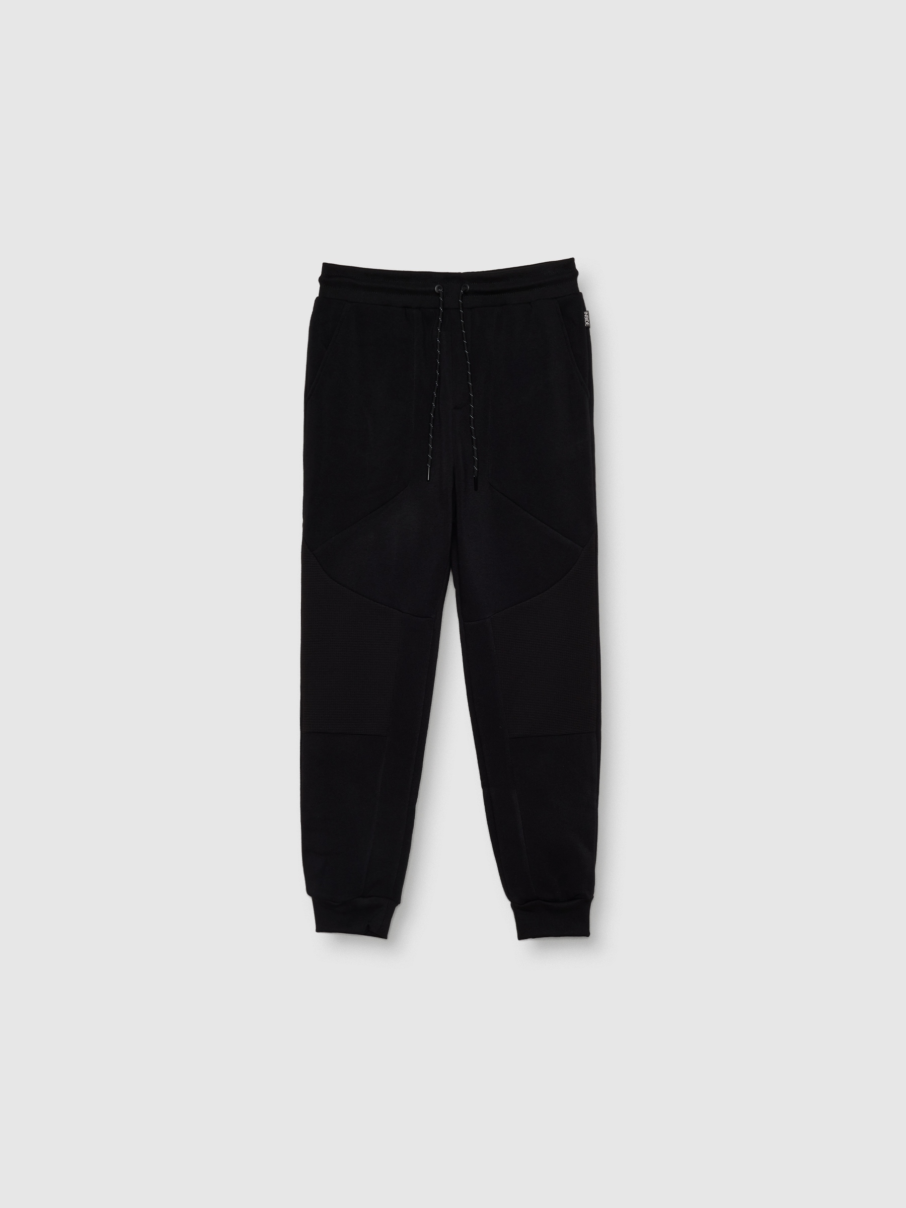 Pantalón jogger deportivo básico acabado en puño, confeccionado en tejido de felpa, color negro INSIDE