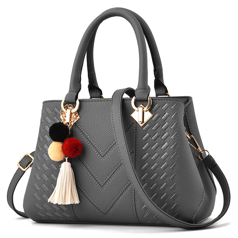 Bolso de mano para mujer, tipo bandolera con asa superior, decorado con pompones y borlas
